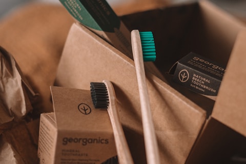 green and white toothbrush on brown carton box