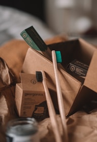 green and white toothbrush on brown carton box