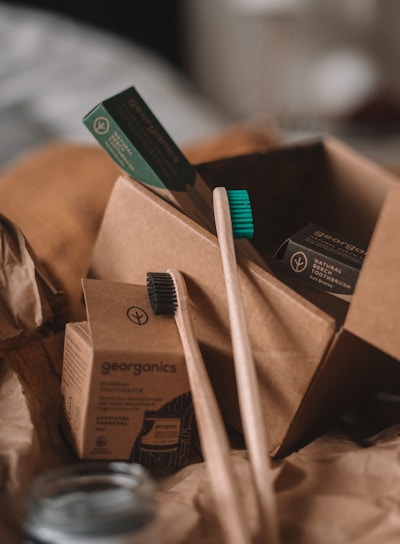 green and white toothbrush on brown carton box