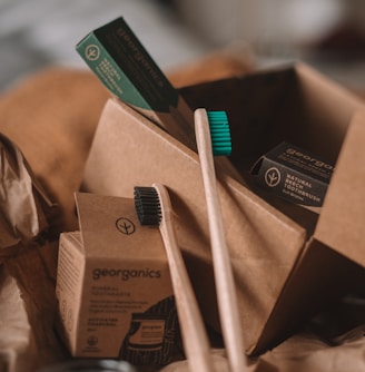 green and white toothbrush on brown carton box