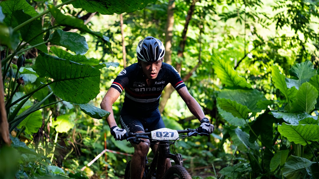 man in black and red long sleeve shirt riding black mountain bike