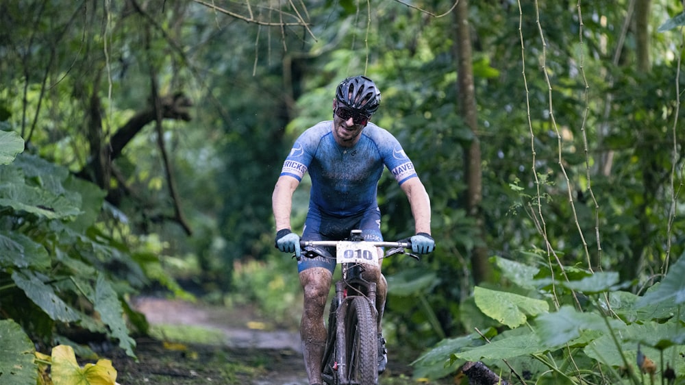 man in red and black long sleeve shirt riding on black mountain bike