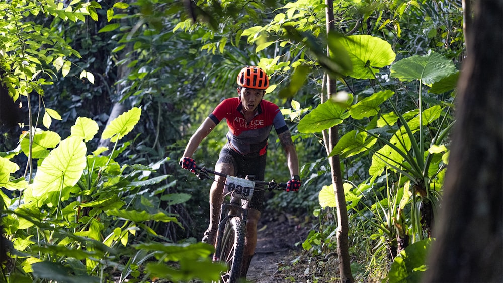 man in red and black long sleeve shirt riding on black mountain bike