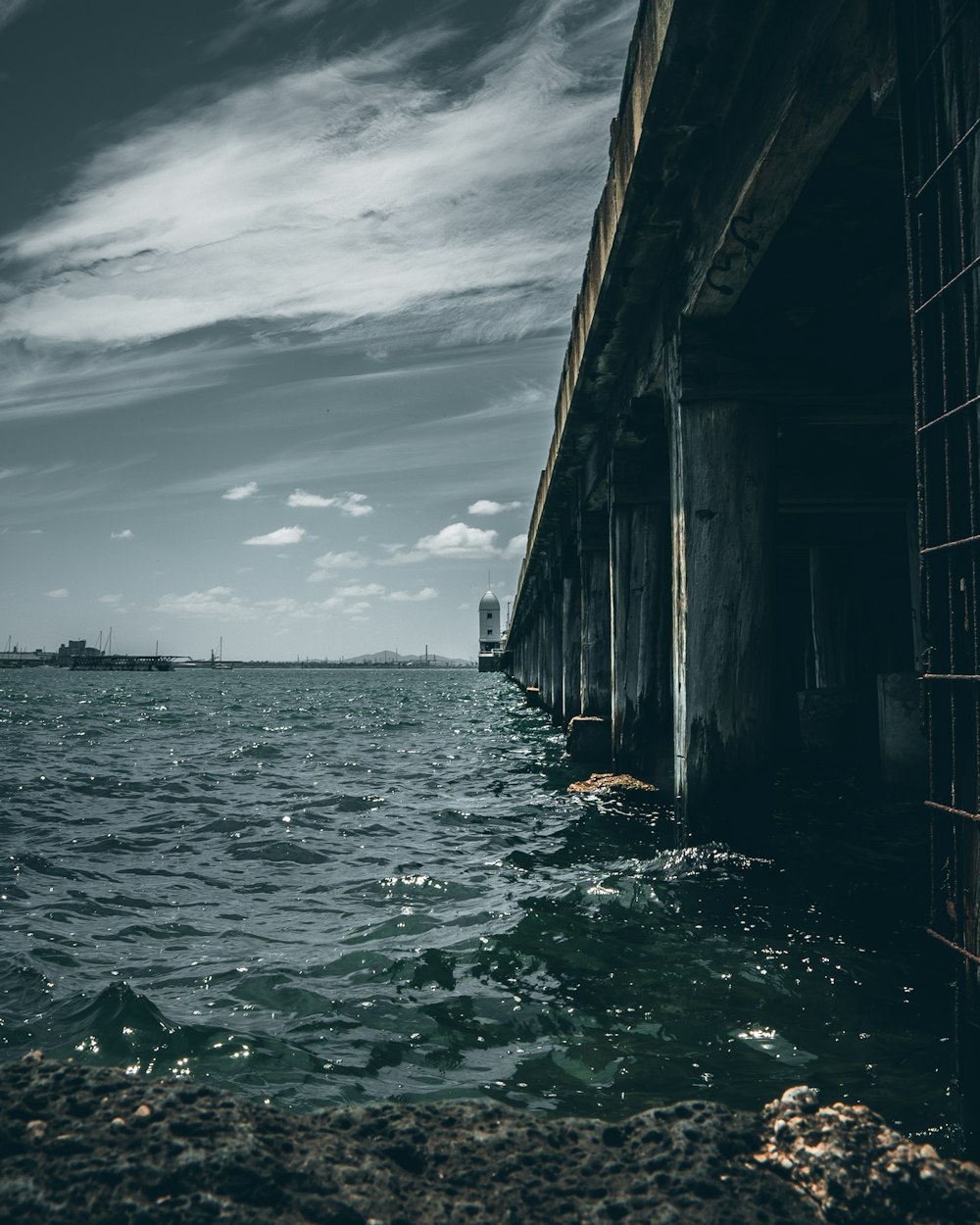 muelle de madera marrón en el mar bajo el cielo nublado durante el día