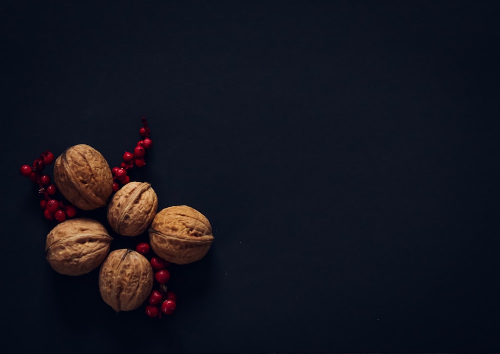 brown and red nuts on black surface