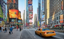 cars on road near high rise buildings during daytime