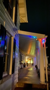 Evening shot of a container home lit up with string lights on the porch.