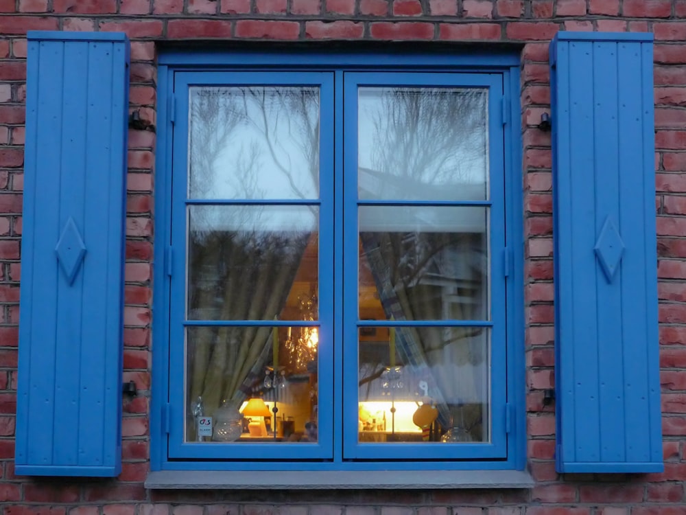 blue wooden framed glass window