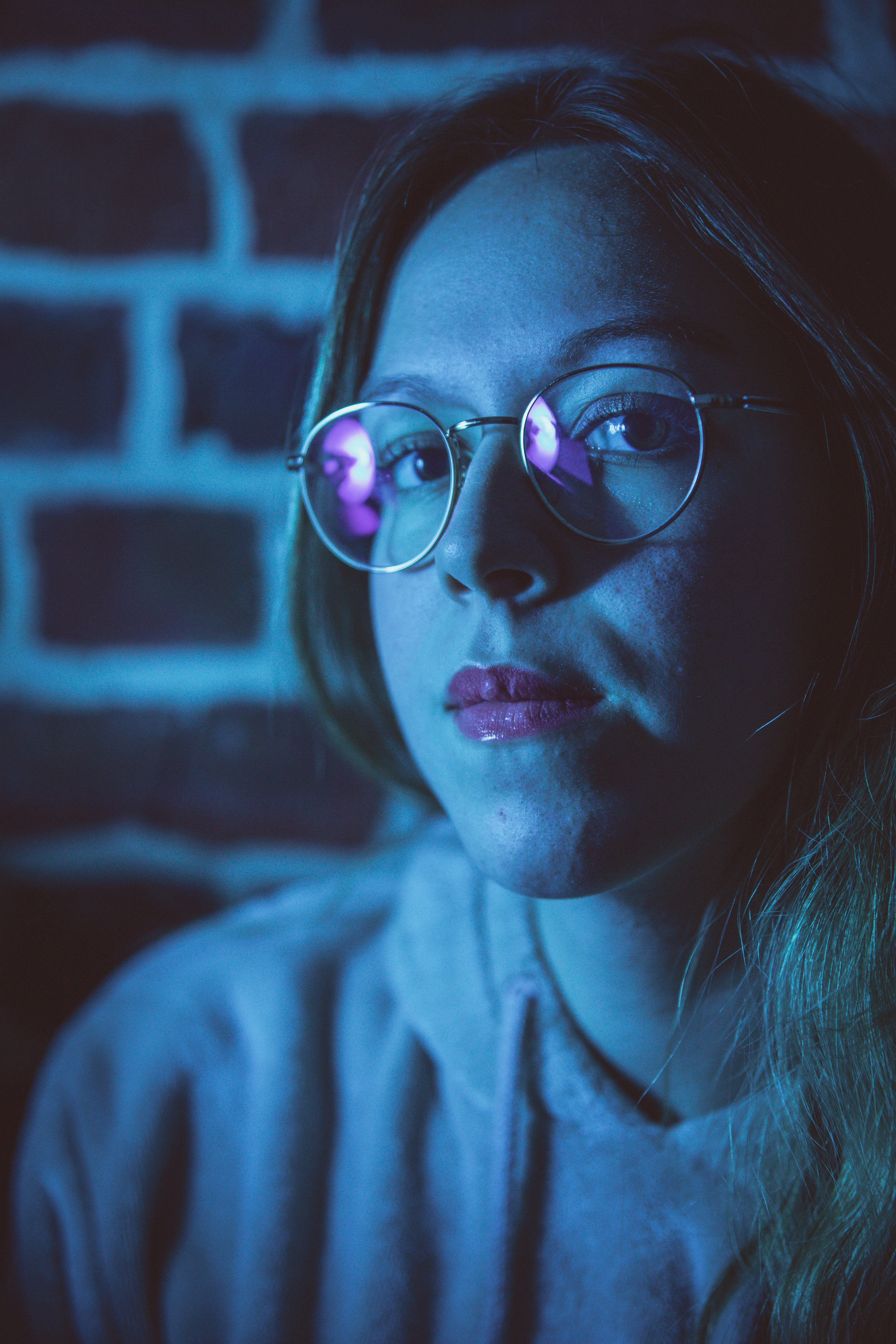 woman in gray hoodie wearing black framed eyeglasses