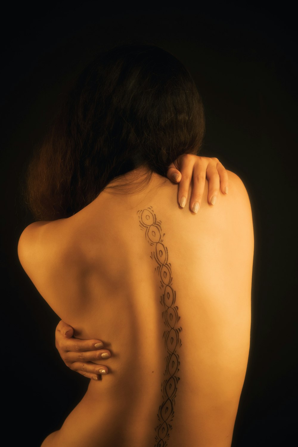 woman with black floral tattoo on her back