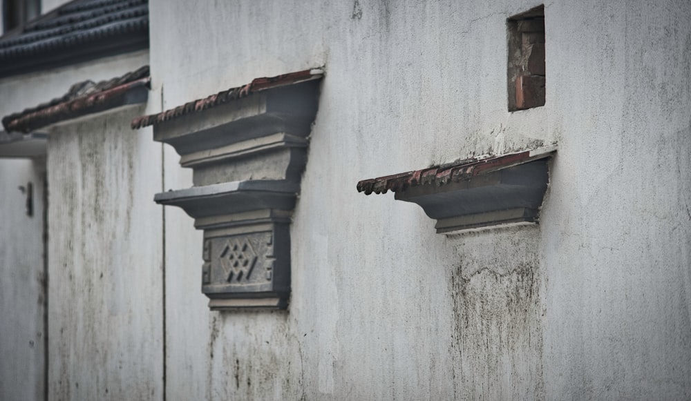 brown wooden window on white concrete wall