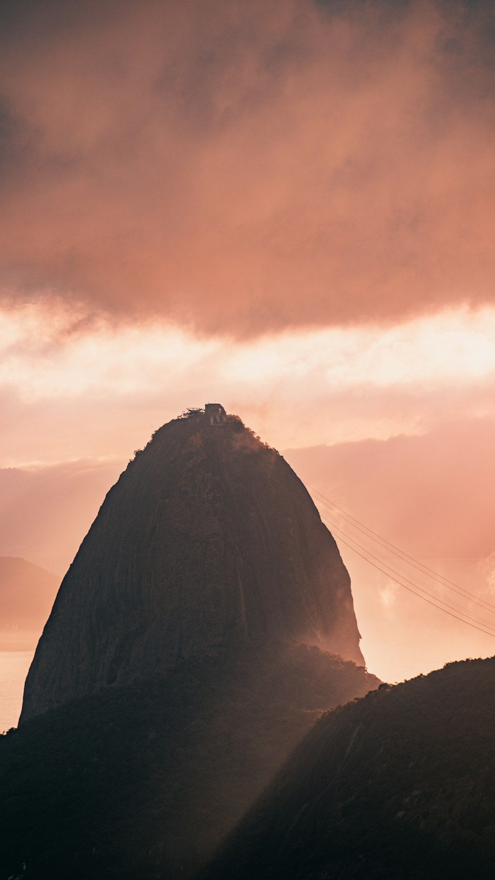 brown rock formation under orange sky