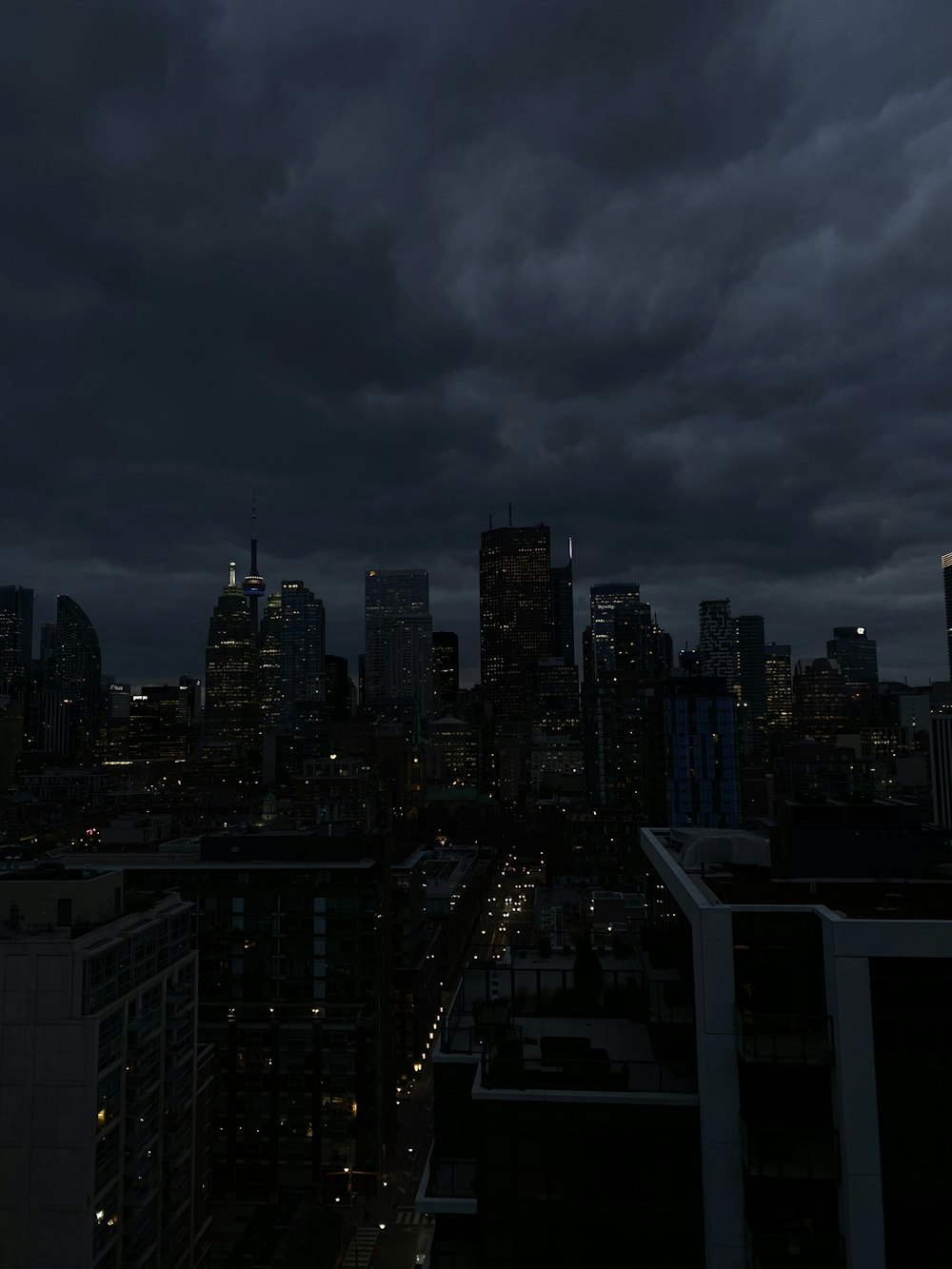 夜間の灰色の曇り空の下での街のスカイライン