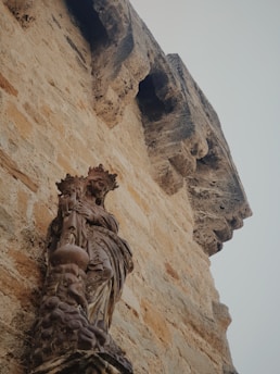 A weathered architectural drawing of an ancient financial stronghold mingled with symbols of legacy and power.