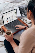 woman in white shirt using black laptop computer