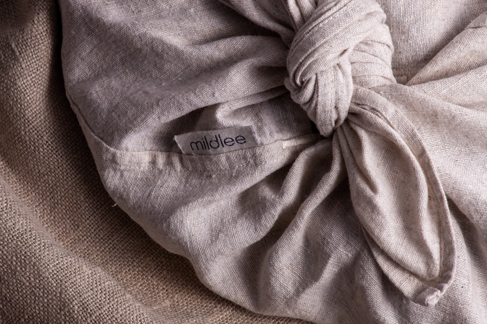 white textile on brown textile