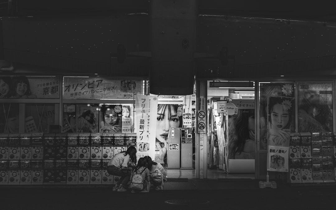 grayscale photo of people in store