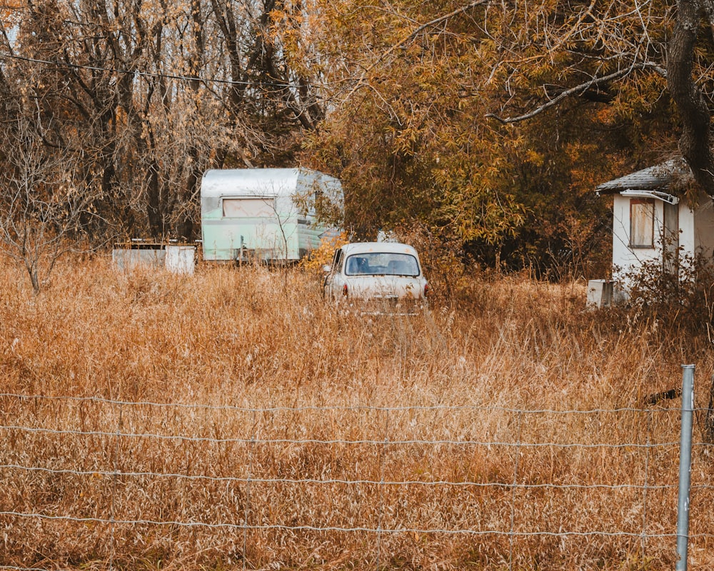 white van on brown grass field during daytime