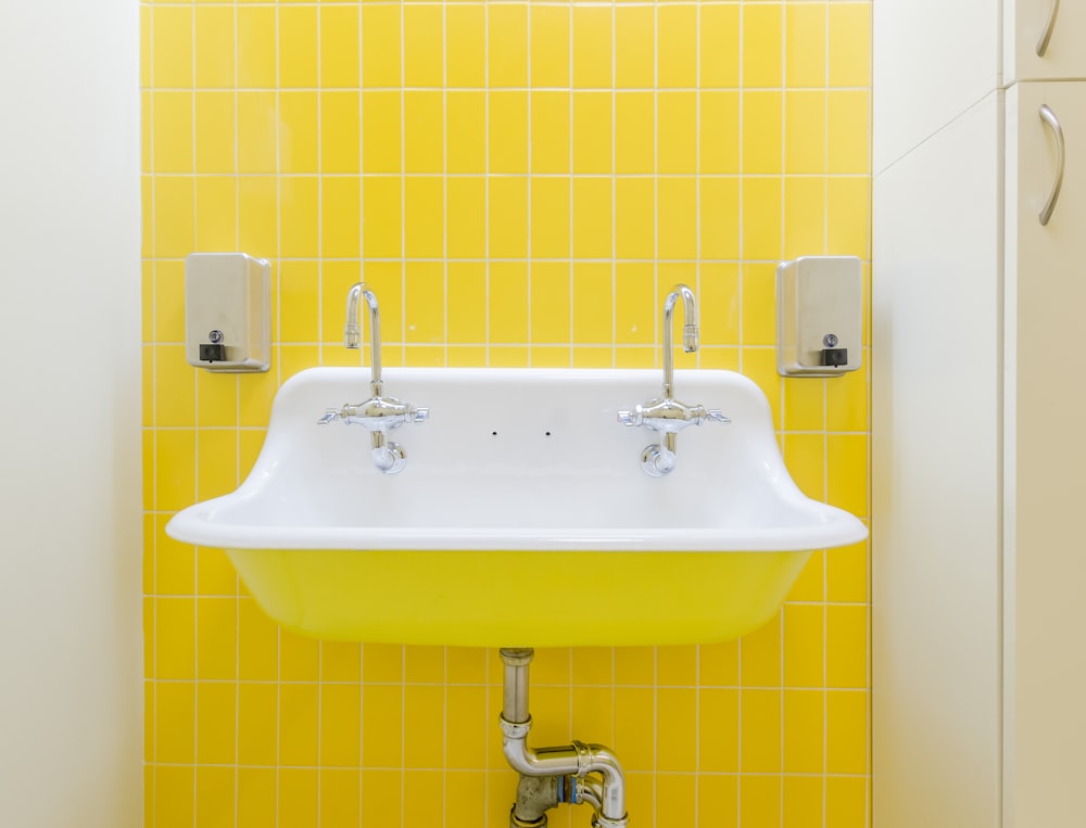 white ceramic sink with stainless steel faucet