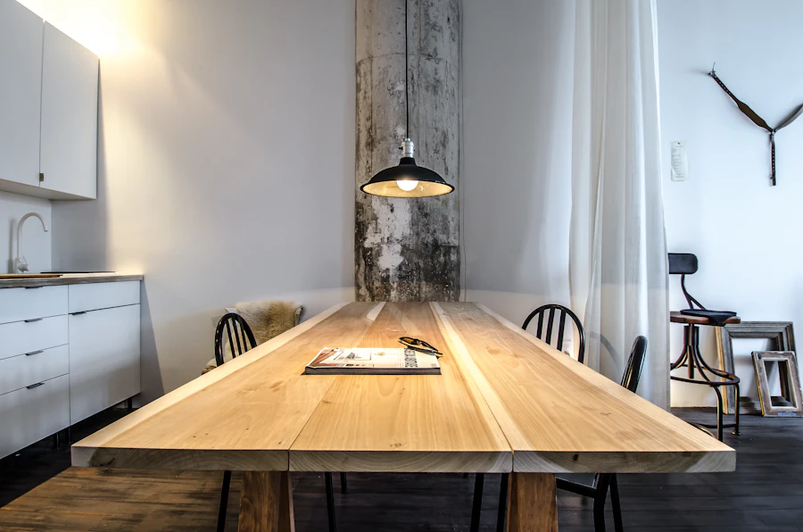 Kessler dining table — a solid wood dining table with chairs beneath a pendant light