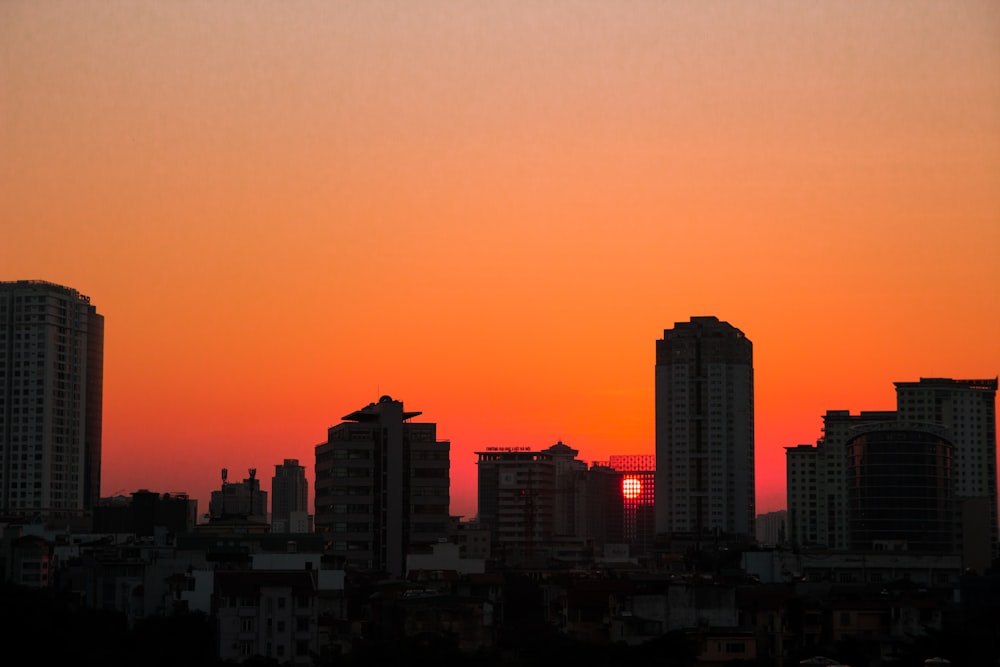 silhouette of city buildings during sunset