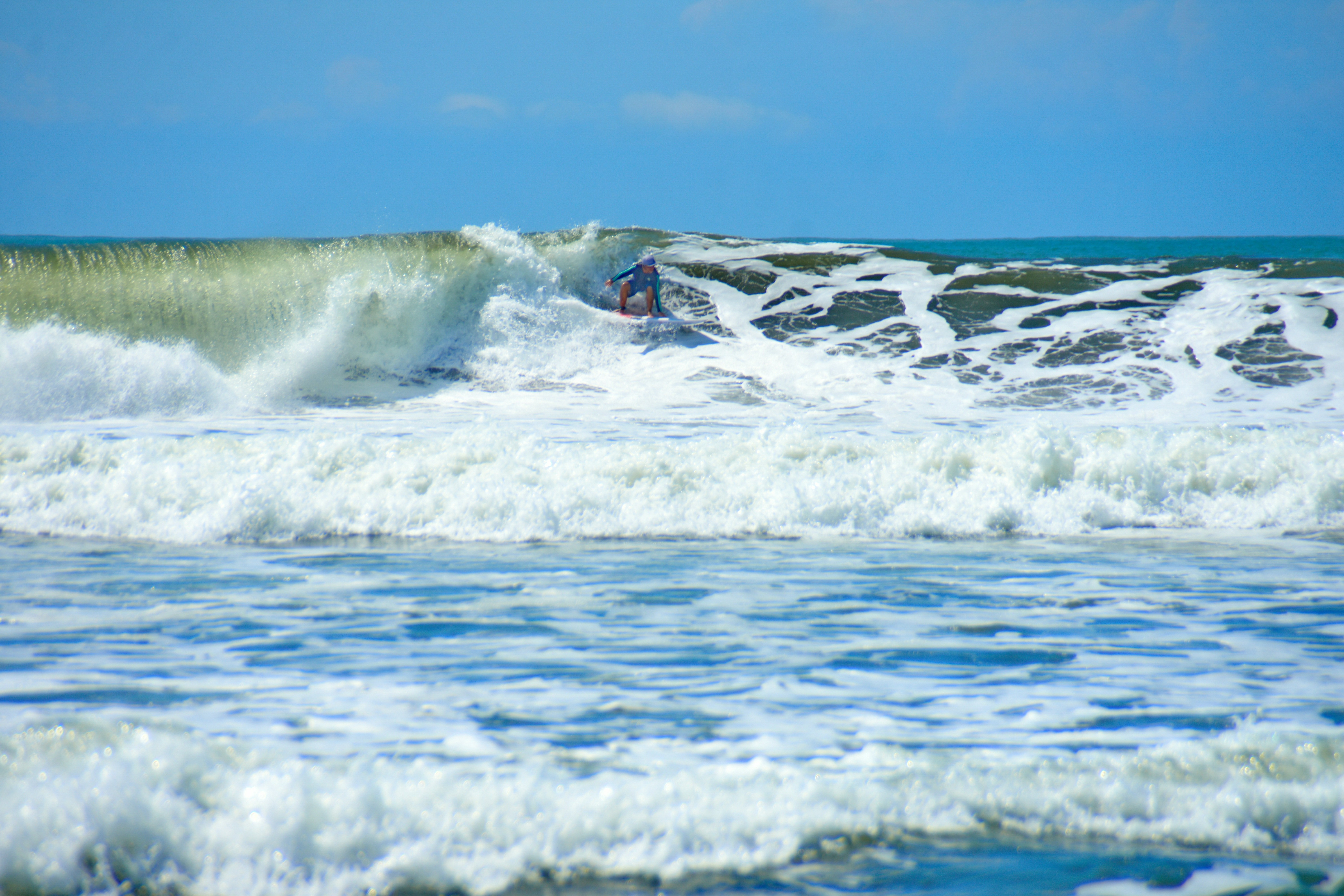person surfing on sea waves during daytime