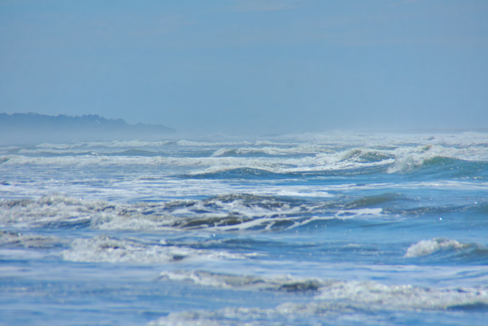 ocean waves under blue sky during daytime