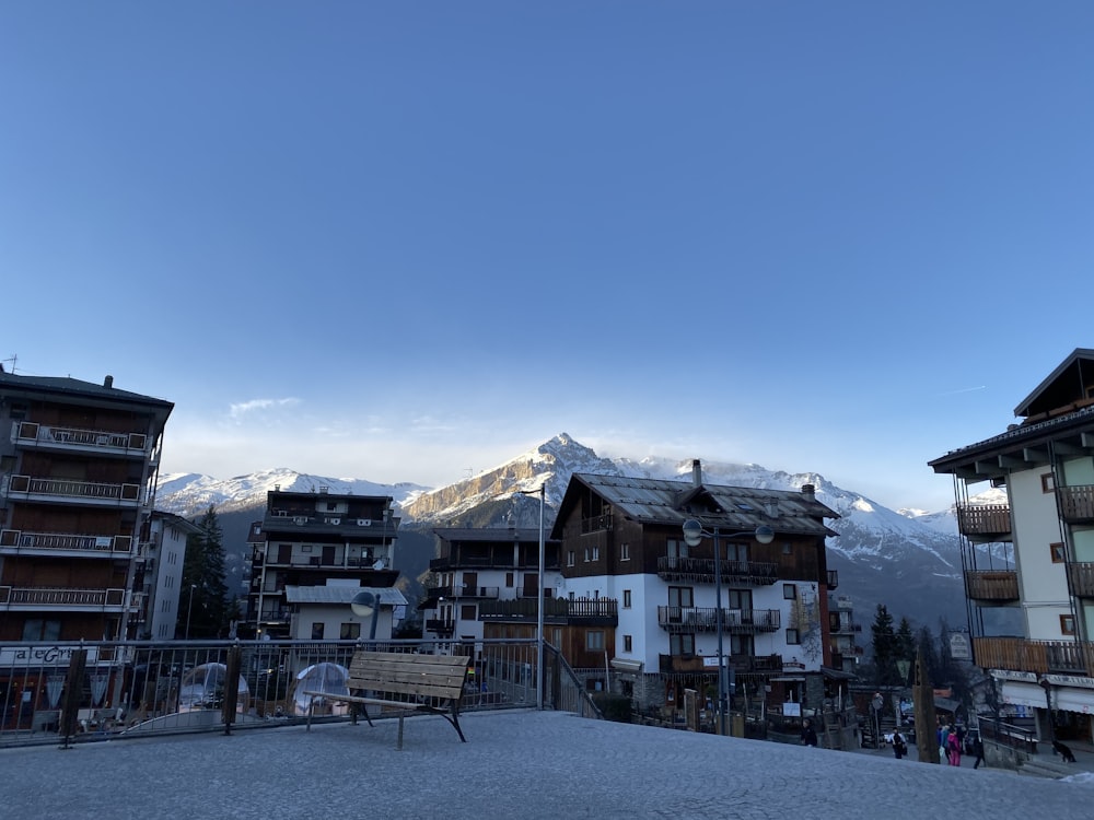 white and brown concrete building near mountain under blue sky during daytime