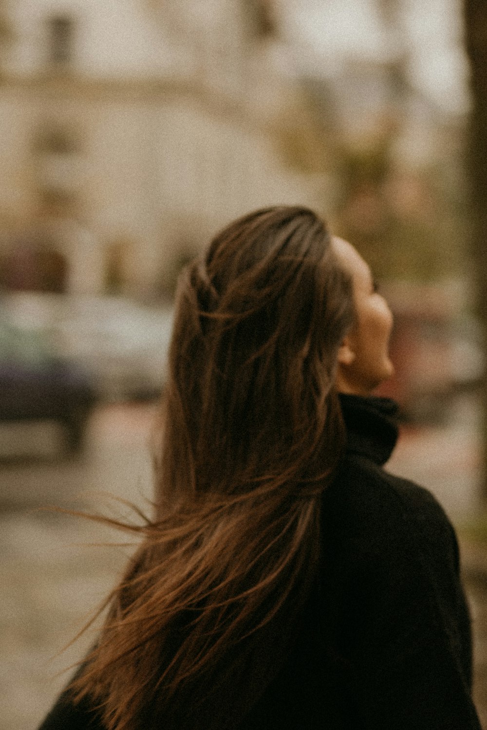 woman in black coat standing