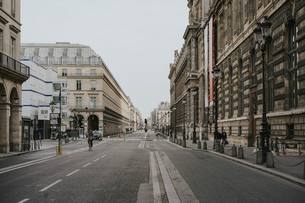 people walking on sidewalk near buildings during daytime