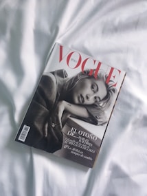 A fashion magazine titled Vogue Mexico is placed on a white surface. The cover features a black and white portrait of a person in a thoughtful pose, with the magazine title in bold red letters.