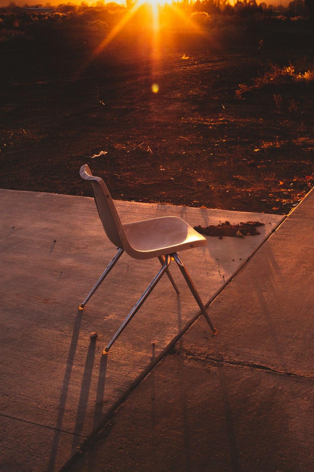 a chair sitting on top of a cement ground