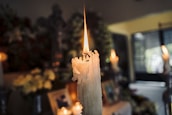 A close-up of a glowing candle flame representing divine blessings.