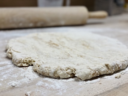 white dough on brown wooden table