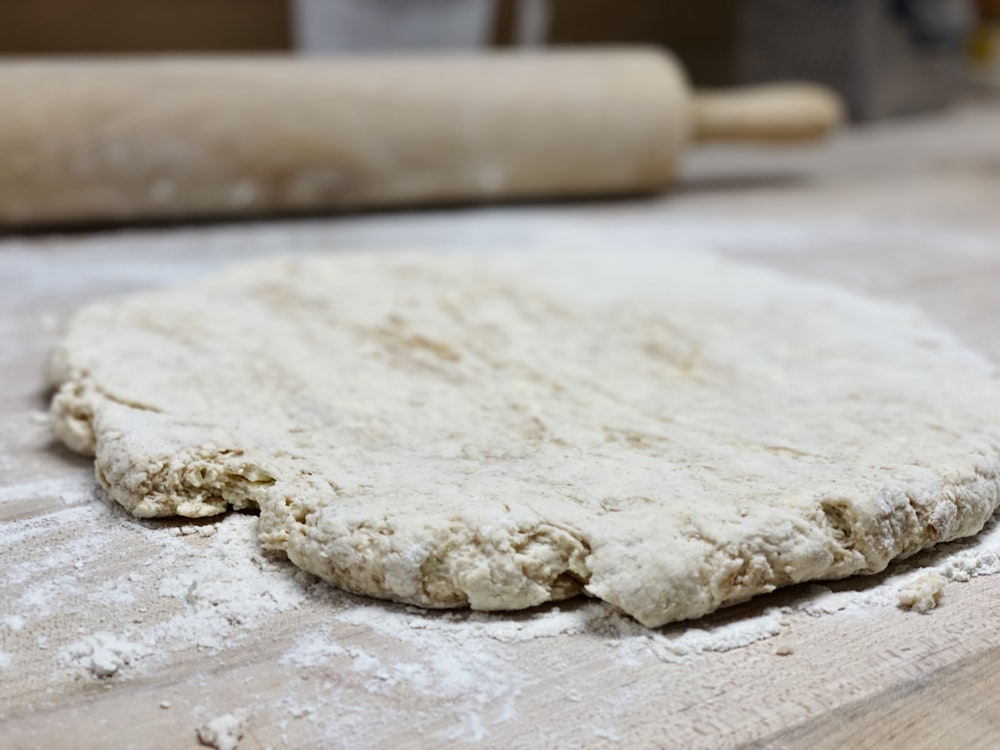 white dough on brown wooden table