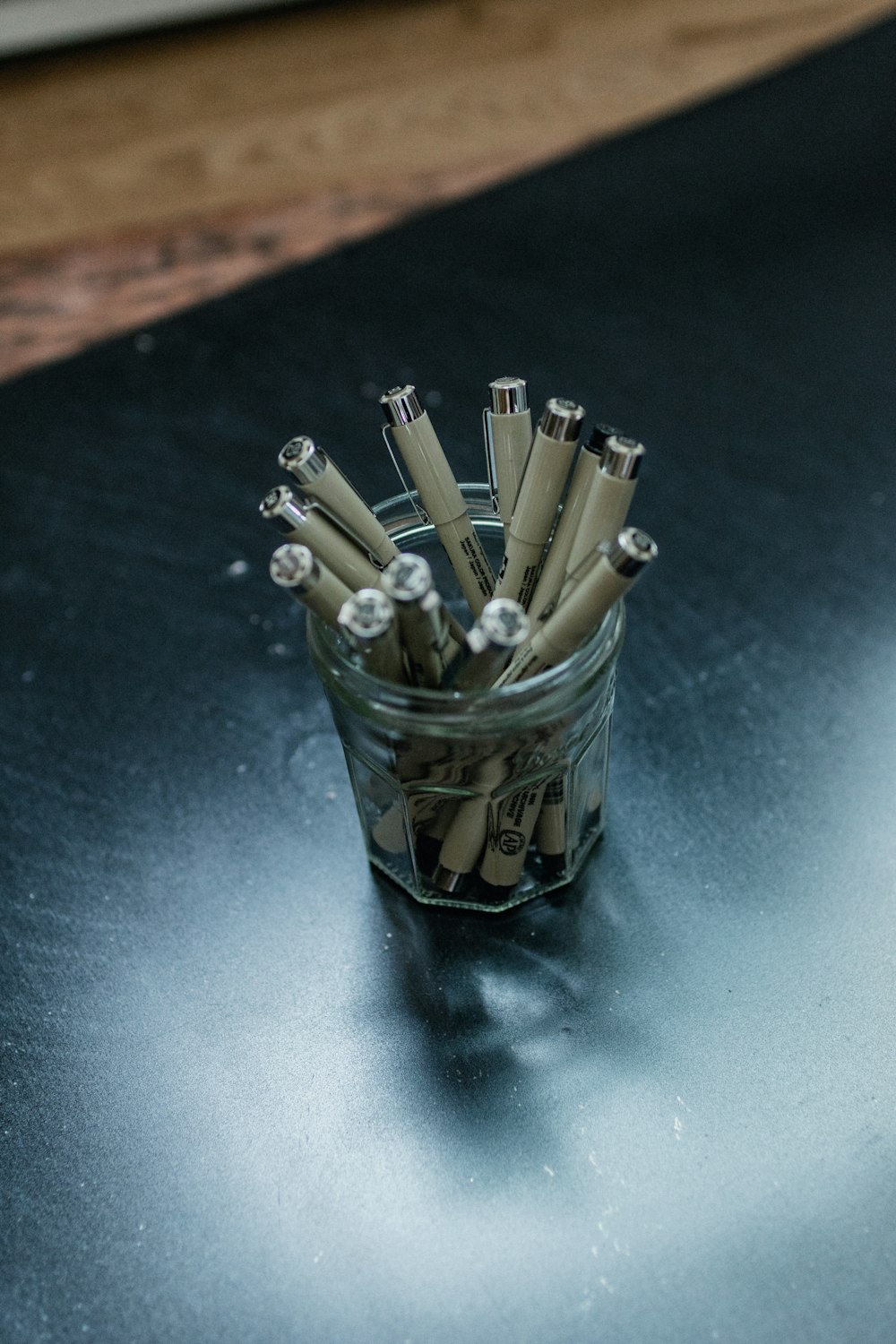 white pencils in black and white plastic cup