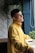 A bright, cheerful person practicing a simple daily habit in a cozy home environment.