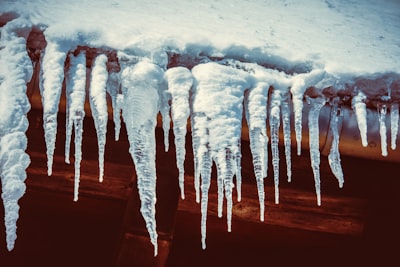 white ice on brown wooden table icicle zoom background