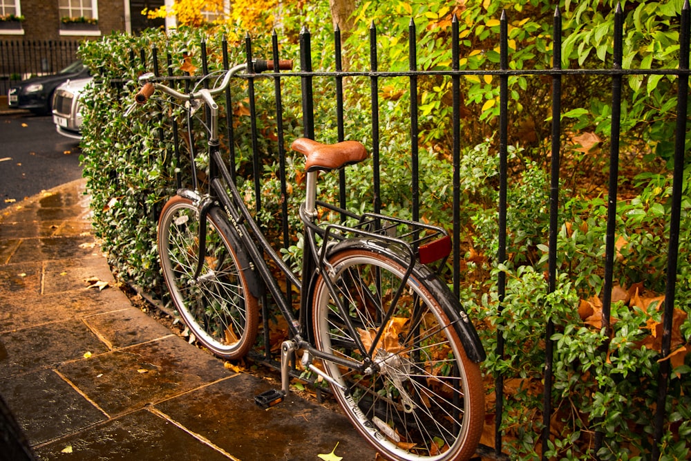 black bicycle parked beside yellow flowers