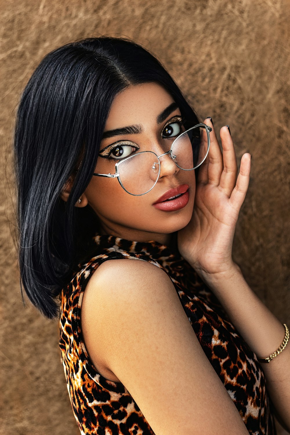 woman in brown and black leopard print shirt wearing eyeglasses