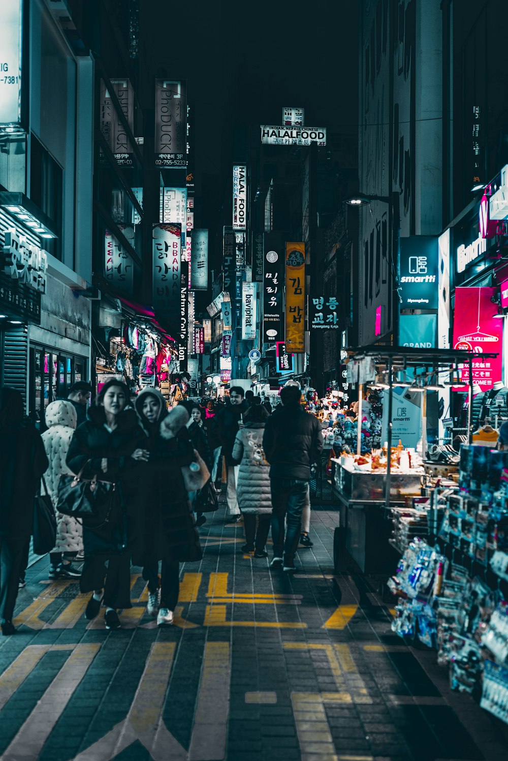 people walking on pedestrian lane during night time