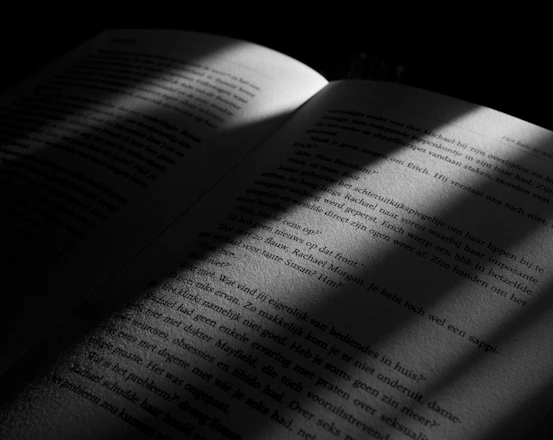 A modern, open book with vibrant pages symbolizing the unfolding story of the play.