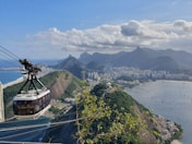 brown and green mountain beside body of water during daytime