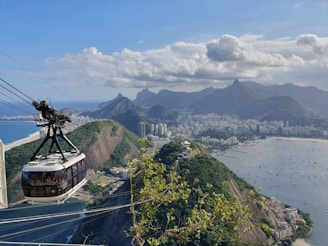 brown and green mountain beside body of water during daytime