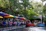 people riding on red boat on river during daytime