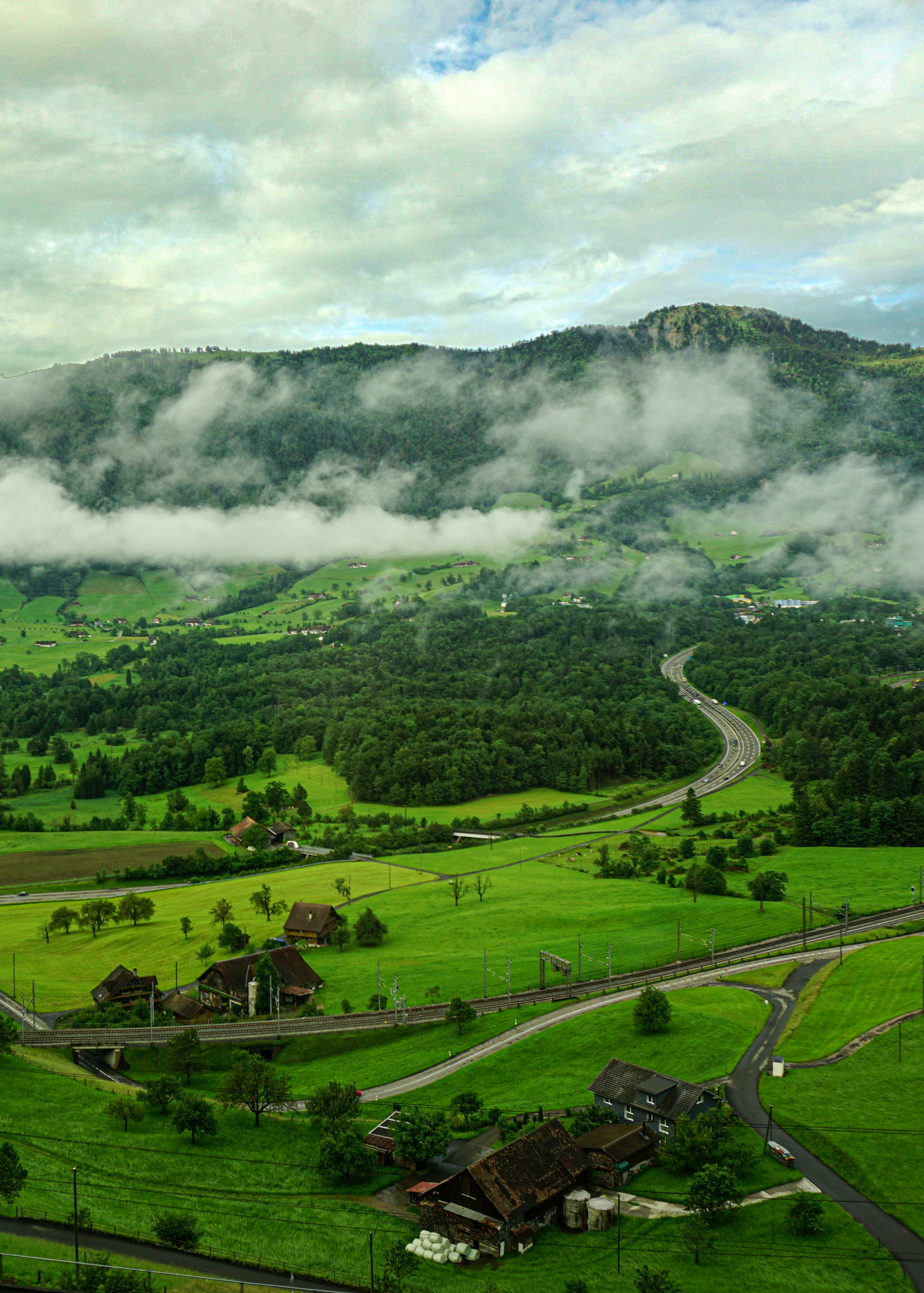green grass field near mountain during daytime
