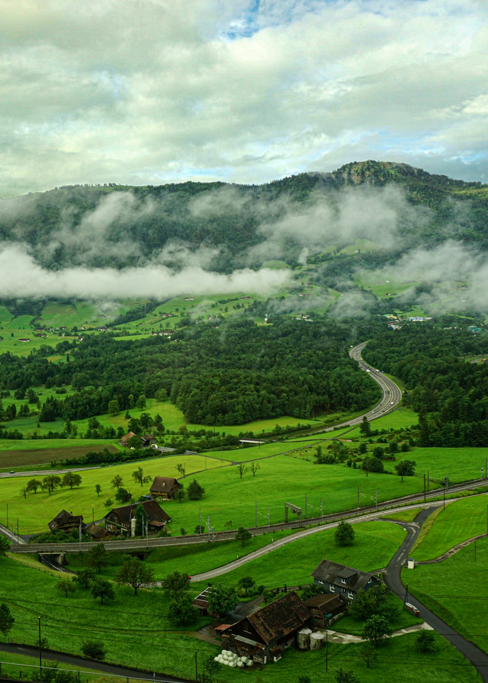 green grass field near mountain during daytime