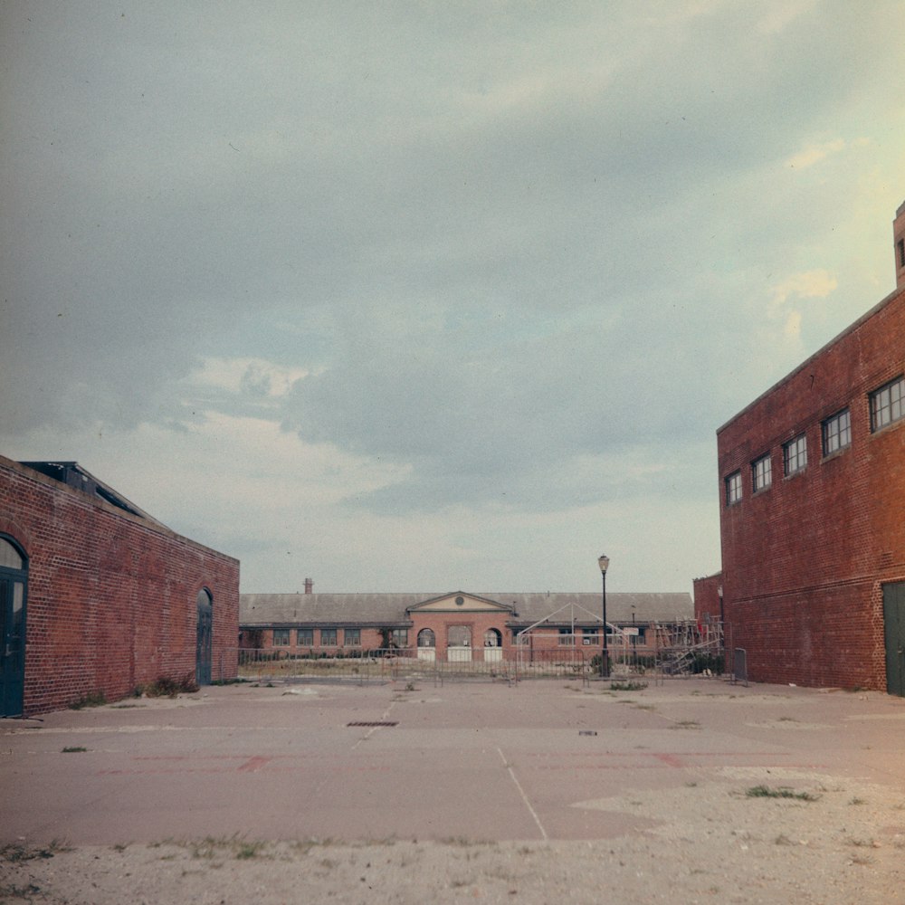 brown concrete building under white clouds during daytime