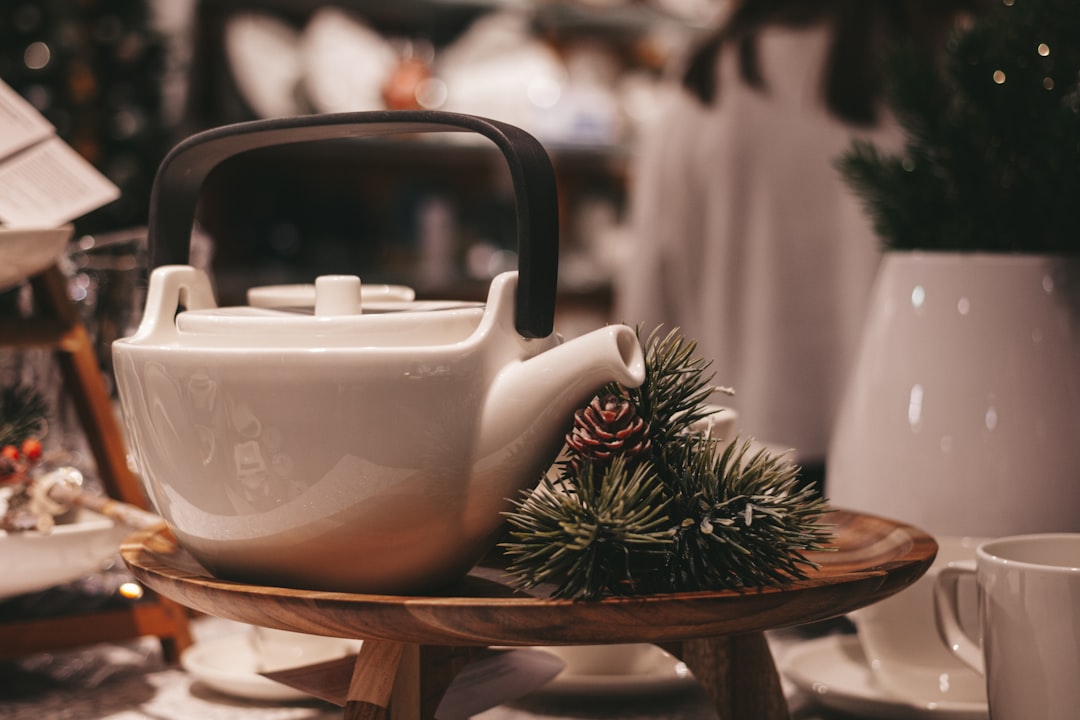 white ceramic teapot on brown wooden table