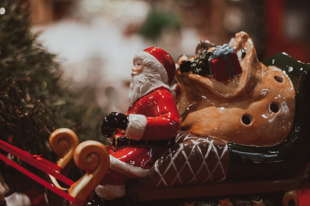 santa claus riding red car figurine